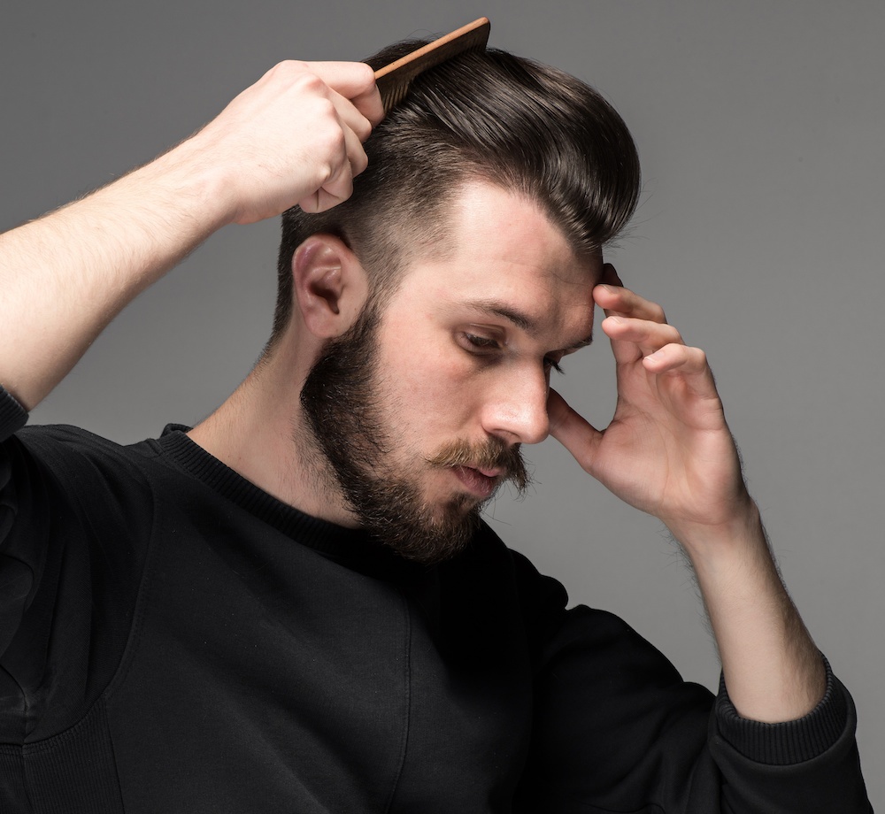 young man combing his hair