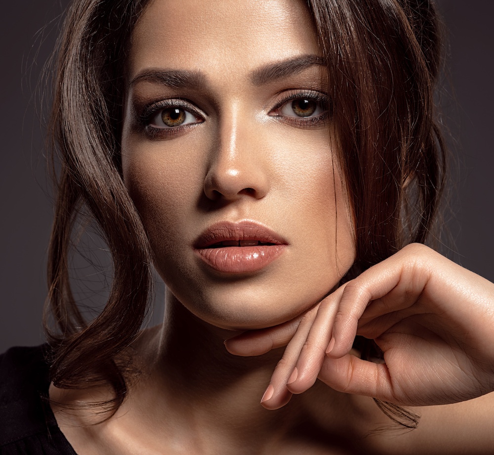 beautiful young woman on dark background